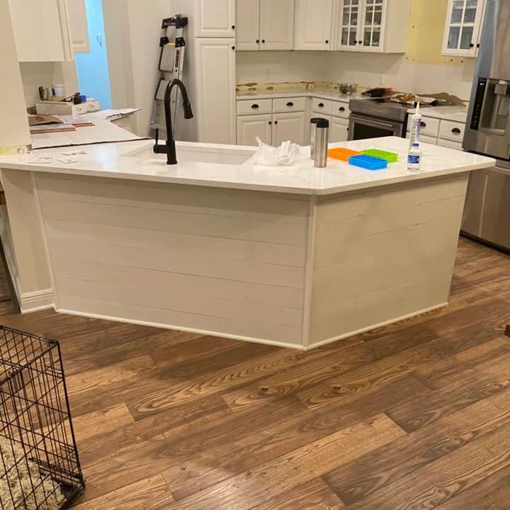 a view of the newly remodeled kitchen with new wood floorings